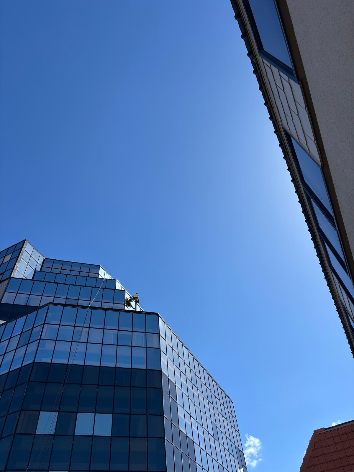 Rope access technician working on building facade in Tauranga